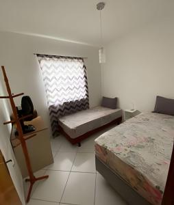 费拉迪圣安娜Ap 2/4 Prox ao shopping的一间卧室设有两张床和窗户。