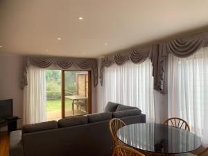 卡尔斯Beach Park Phillip Island - Apartments的带沙发和玻璃桌的客厅