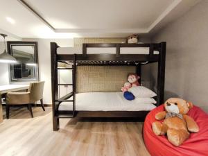 曼谷Citrus Suites Sukhumvit 6 by Compass Hospitality的两只填充的动物坐在双层床上
