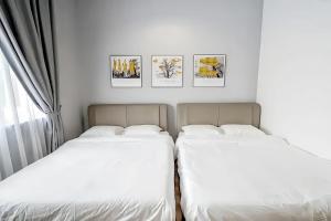 丹那拉打The Quintet Tanah Rata的卧室内的两张床,墙上挂有照片