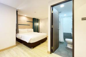 曼谷City Park Hotel Bangkok Pratunam by PCL的一间卧室配有一张床,浴室设有卫生间