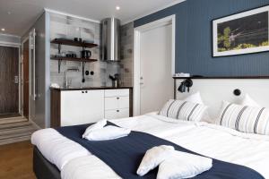 卡尔斯库加Lakelodge的一间带白色大床的卧室和一间厨房