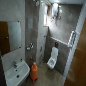KurmannapalemHappy Nest Guest Home的一间带水槽、卫生间和镜子的浴室