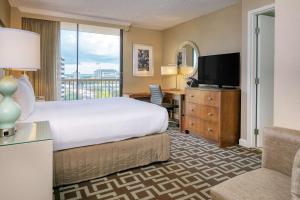 杰克逊维尔佛罗里达州杰克逊维尔河滨希尔顿逸林酒店的酒店客房,配有床和电视