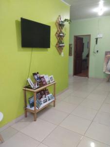 帕林廷斯Casa Parintins的一间在绿色墙上配有电视的房间