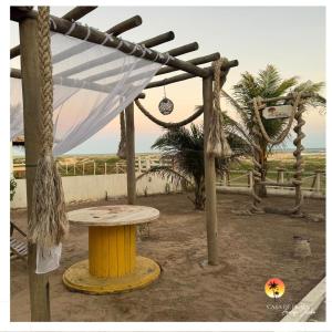 巴拉杜斯科凯鲁斯Casa de Praia - Aracaju - Jatobá的一张带帐篷和棕榈树的野餐桌