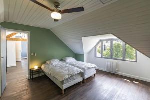 EsterreSuperbe villa familiale - 1408的一间卧室配有一张床和吊扇