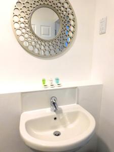 汉密尔顿Newly refurbished 2 bedroom apartment close to station and local amenities的浴室设有白色水槽和镜子