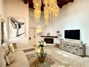 卡拉隆加Ipunga Ibiza - Adults only的一间带电视和花瓶的客厅