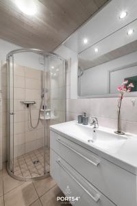 温德托尔夫Ferienhaus Möwennest Marina Wendtorf的带淋浴和白色盥洗盆的浴室