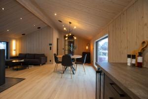 弗洛High standard cabin in a quiet area in the bossom of nature near Flå的厨房以及带桌椅的起居室。
