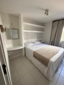 里约热内卢Apê na Gávea的白色卧室配有床和镜子