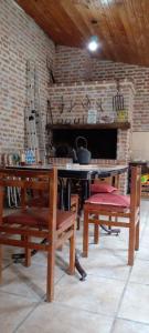 拉巴斯Departamento con quincho h/5 huéspedes的客房设有桌子、长凳和壁炉。