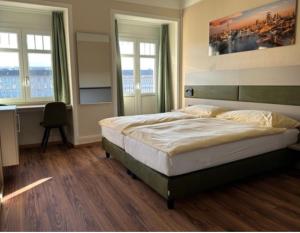 卢塞恩匹克威克酒店及酒馆“看得见风景的客房”的卧室配有一张床、一张书桌和窗户。