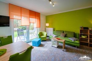 韦尼格罗德Auszeit-im-Harz Haus 6 Wohnung 3的客厅配有绿色沙发和桌子