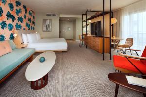 檀香山雷洛傲途格精选酒店的酒店客房配有床、沙发和电视。