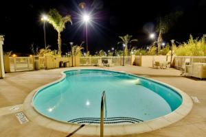 莫雷诺谷Hampton Inn & Suites Moreno Valley的夜间大型游泳池,灯光照亮