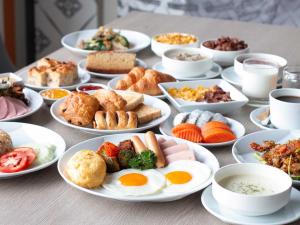 曼谷宜必思尚品曼谷素坤逸4酒店 的一张桌子上放着许多盘子的食物
