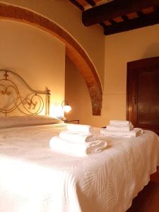 切托纳agriturismo il Borgo的卧室配有白色床和毛巾