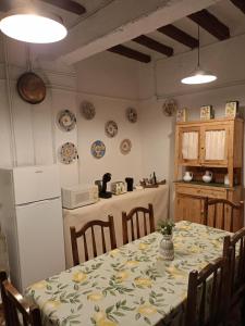 CadreitaCasa rural de la Abuela的一个带桌子的厨房和一个带板子的墙上厨房
