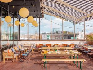 旺夫Eklo Paris Expo Porte de Versailles的餐厅设有桌椅和大窗户。