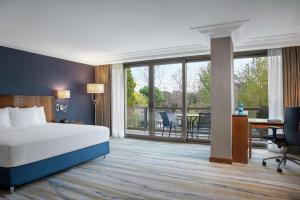 伊斯坦布尔希尔顿伊斯坦布尔博斯普鲁斯酒店的酒店客房设有一张床、一张书桌和一个阳台。