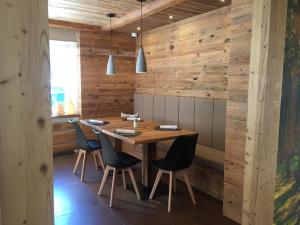 卡纳泽伊Fedaia Joy B&B的木制用餐室配有木桌和椅子