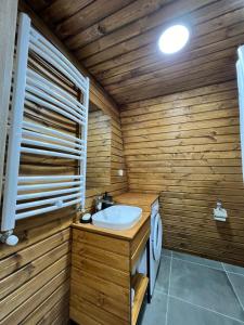 KʼumlistsʼikheGudauri Sikhaura的木制浴室设有水槽和卫生间