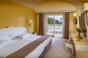 哈马马特Mediterranee Hammamet- Families and Couples Only的酒店客房设有一张大床和一个阳台。
