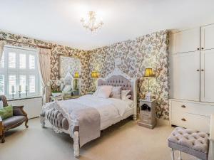考布里奇Llwynhelig House - Uk46395的一间卧室配有一张床和花卉壁纸
