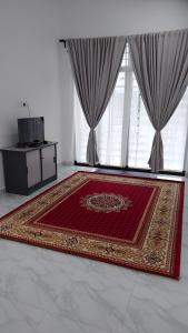 MacangHomestay Rumi的窗户前有地毯的房间