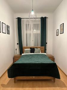 克拉科夫Wielopole Classy Rooms的一间卧室配有一张带绿毯的大床