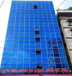 达卡Hotel living international ltd.的一座高大的蓝色建筑,前面有标志