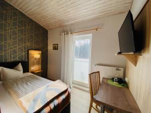 上舍纳祖尔库特斯赫酒店的一间卧室配有一张床、一张桌子和一个窗户。