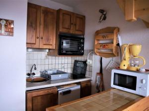 奥瑞斯Appartement Auris, 1 pièce, 4 personnes - FR-1-297-158的厨房配有水槽和微波炉