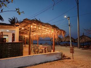Playa Punta ArenaPunta Arena Beach Hostel的海滩上带桌椅的餐厅