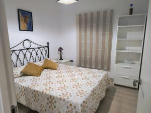 塞维利亚Casa El limonero的一间卧室配有一张带花卉床罩的床