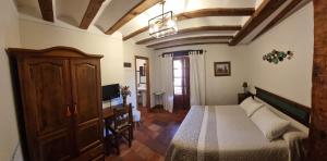 艾利翁阿达尔维乡村酒店的一间卧室配有一张床,并在一间客房内配有电视。