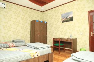 杜尚别Yellow Hostel Dushanbe的客房设有两张床、一张桌子和一张桌子。