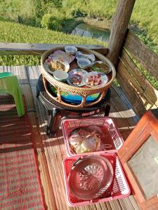 Ban Mae Pan Noiบ้านพักชิปู ป่าบงเปียง的木桌上的烤架,上面有食物