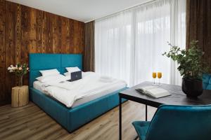 什平德莱鲁夫姆林Avenue Chalet的一间卧室配有一张蓝色的床和一张桌子