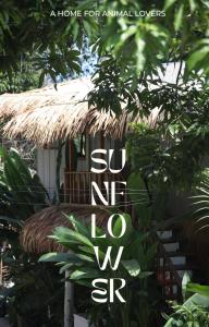 丽贝岛Sunflower Guesthouse and Animal Rescue - Koh Lipe的标语 不能在草屋前