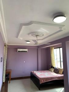 库马西Kate Villa的卧室拥有紫色的墙壁和天花板