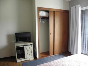 奥尔塔Alice´s House的一间卧室设有衣柜、电视和门