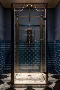 KildrummyKildrummy Inn的浴室铺有蓝色瓷砖,设有淋浴。