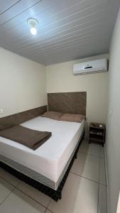瓜鲁柳斯Hostel Quartos com banheiro individual perto do Aeroporto的一间卧室,卧室内配有一张大床