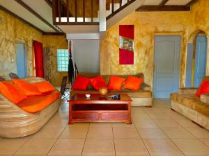 克里比La Villa Lou, Musée Des Arts Grand Batangua的客厅配有沙发和桌子