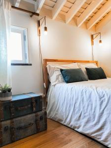 诺德什蒂Casas da Chaminé Eco Country Lodge的一间卧室配有一张床和一个古老的箱