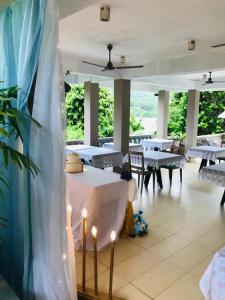 马埃岛Bayview Villa -Sea Side Villa的用餐室配有桌椅和灯光