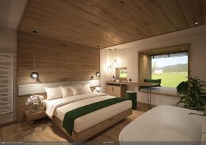 科雷多Pineta Nature Resort - Wellness & SPA的一间卧室设有一张大床和一个浴缸